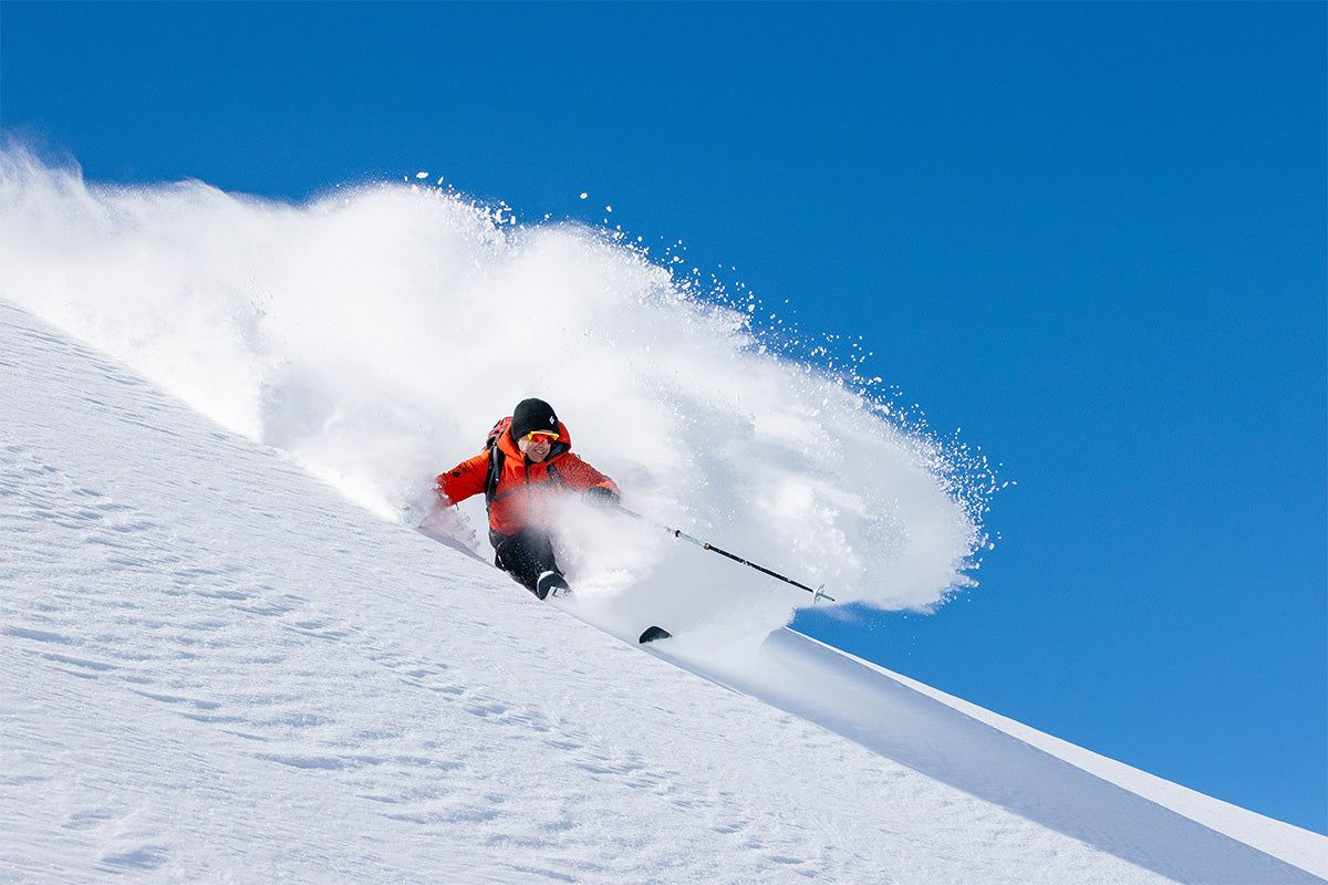 Skidåkare lägger en pudersväng